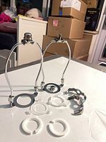 Top view showing two assembled stainless wire clamps, white plastic rings, star clips
