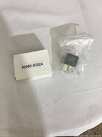 Relay in sealed bag beside labeled box