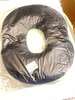 front view of donut seat cushion sealed in plastic