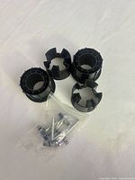 Top view of four insert end caps and bagged hardware