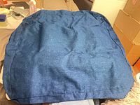 Stack of four navy woven fabric bags displayed flat