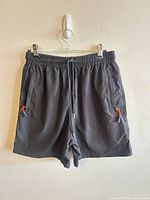 Front view showing overall design, elastic waistband, drawstring, zip pockets