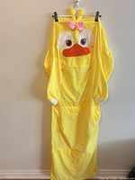 Full view of yellow chicken pattern chair cover hanging on clips