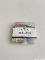 Front view of sealed Creatcabin kit showing label and assorted contents inside