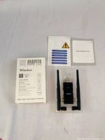 Front of retail box, adapter in tray with two antennas and paperwork