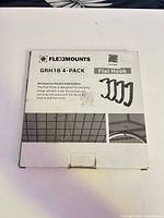 Front of retail box showing FlexiMounts branding, model GRH1B 4-Pack, product illustration
