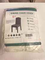Front of sealed package showing product information and image of slipcover on chair