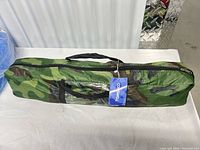 Overall view of camouflage bag with hang tag visible