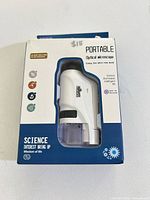 Front of opened box showing stapler through window and printed blue packaging