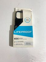 Front of retail package showing LifeProof WAKE black phone case and compatibility info
