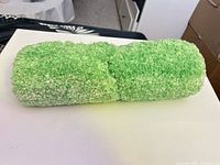 Rolled light green microfiber bath rug