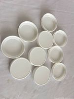 Top view of ten white plastic screw-on caps