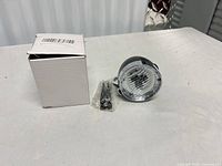 Headlight, hardware pack and retail box on tabletop