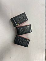 Three boxed mini Bluetooth game controllers front view