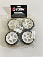 Front view of sealed package containing four RC car wheels and tyres