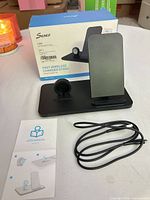 Charger stand, cable, manual, and retail box front view