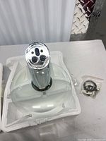 Top view of chrome faucet showing three inlet holes