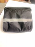 Front view of black insulated pouch showing reflective stripe and zipper top