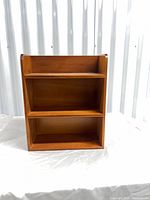 Front view of teak-tone three-shelf wood veneer unit