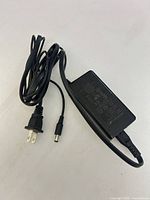 Entire adapter showing AC plug, DC barrel plug and housing