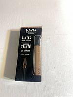 Front of sealed NYX Tinted Brow Mascara box with tube visible