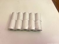 Front view of ten shrink-wrapped thermal paper rolls