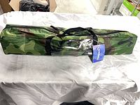 Tent packaged in camouflage carry bag with tag