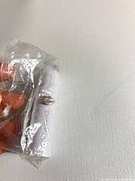 Sealed white lipstick tube in shrink wrap showing color indicator