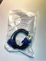 Sealed package containing VGA male-to-male cable with warranty card visible