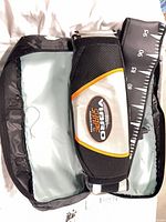 Belt inside open zip case showing strap and control end