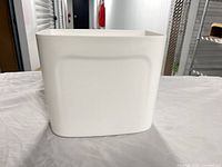 Front view of white rectangular hard plastic storage bin