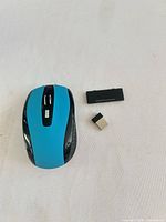 Top view showing mouse, USB receiver, battery cover
