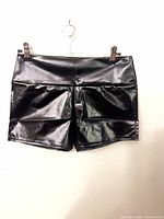 Front view of black faux leather women's shorts