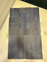 stack of six indigo blue vinyl placemats