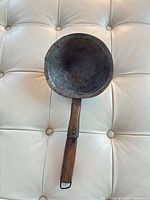 Full view of copper ladle bowl and wooden handle