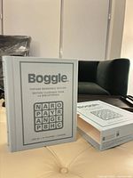 Closed faux-book Boggle case standing on surface