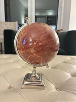 Oblique front view showing globe, meridian, and base