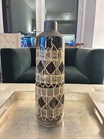 Full view of cylindrical ceramic vase showing overall design and height