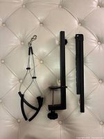 Grooming arm parts, clamp and loops on cushion