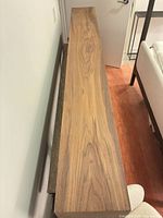 Top view of full walnut mantel showing length and square edges