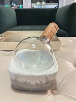 Glass decanter resting in stone base