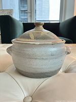 Side view of stoneware Dutch oven with lid showing overall form and glaze