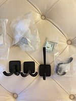 All four wall hooks with mounting hardware displayed