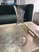 Full view of clear glass decanter on tray