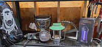 Group shot of catalytic heater, lantern, snorkel set, trailer lift part and boxed mosquito killer