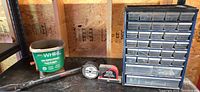 Lot overview showing spreader, bike bar, wire spool, laser level, parts organizer