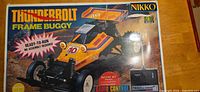 Box top showing Nikko ThunderBolt 1\/10 scale buggy image and branding