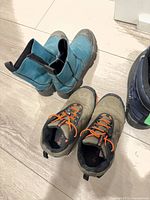Teal ankle boots and olive hikers showing wear