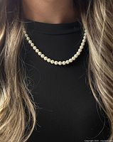 Necklace worn on model showing length and pearl uniformity