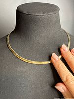 Necklace on display bust showing gold side